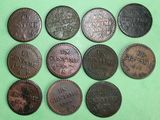 six different types of coins are shown on a green surface
