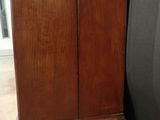 a wooden cabinet with a door on the side of it