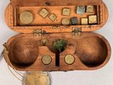 an old wooden box with a bunch of coins inside of it
