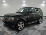 an image of a black land rover parked in a garage