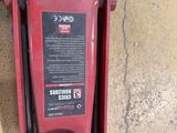 a red machine that is sitting on the ground