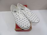 pair of white and grey polka dot shoes on a box