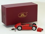 a red model of a racing car next to a red box