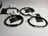 three black leather bracelets with silver clasps on a white surface