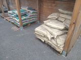a pile of bags of cement next to a pile of bags of cement