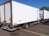 two trucks that are parked in a parking lot