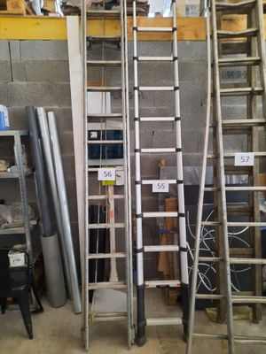 many ladders that are stacked up in a room