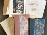 several books sitting on top of a table next to each other