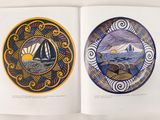 an open book with a picture of a sailboat and a boat on it