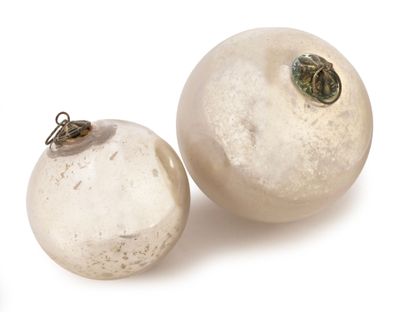 two white glass ornaments on a white surface