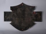 a picture of a metal cross on a white wall