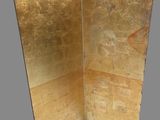 an image of a gold colored folding screen on a gray background