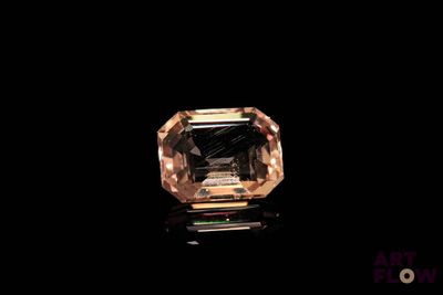 a close up of a diamond on a black surface