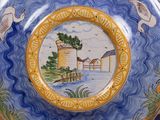 a plate with a picture of a farm on it