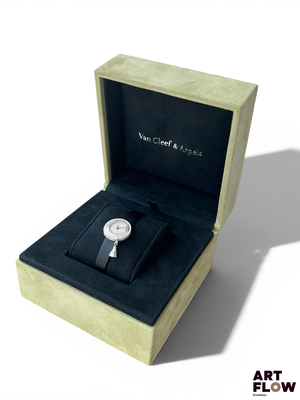 a box with a watch inside of it on a white surface