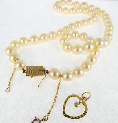 pearl necklace with a gold heart charm and a heart pendant
