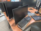 a desk with three monitors and a keyboard on it