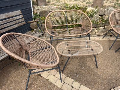 three chairs and a table in a patio area