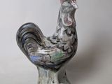 a ceramic rooster with a crown on it ' s head