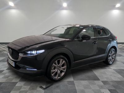 the mazda cx - hr is parked on a checkered floor