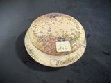 a plate with a hat on it that has a tag on it