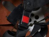 a close up of a helmet with a red button on it