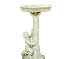 a statue of a boy and a girl sitting on a birdbath