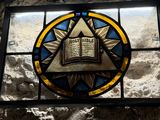 stained glass window with a book and star of david on it