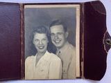 an old photo of a man and woman posing for a picture