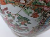 a close up of a vase with a bird on it