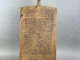 an old piece of paper with a hammer on top of it