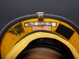 a close up of a person wearing a hat with a sticker on it