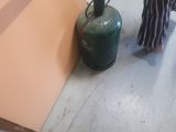 a woman that is standing in the kitchen with her feet on the floor
