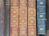 many old books in a cardboard box on the table