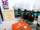 many bottles of liquid sitting on a table next to a box