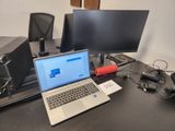 a laptop computer sitting on top of a desk next to a monitor