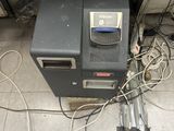 a small machine that is on the floor next to a pile of wires