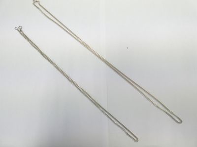 two long silver chains on a white background
