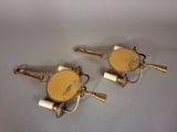 pair of brass plated wall lights with white shades on them