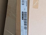 a cardboard box with a label on it sitting on the floor