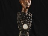 un gros plan sur la statue d'une personne tenant une horloge