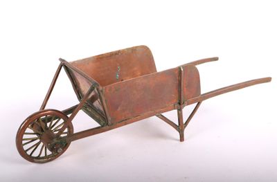 a small wooden wheelbarrow on a white background