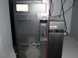 a computer sitting on top of a shelf in a room