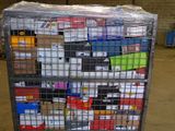 a metal cart with many boxes on it in a warehouse