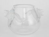 un vase en verre transparent contenant des fleurs, posé sur une table