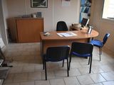 a desk with two chairs and a computer on it