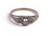a close up of a diamond ring on a white background