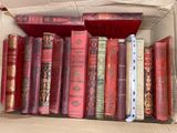 a box full of old books sitting on a table