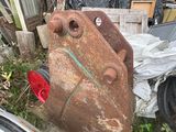 a large piece of rust sitting on the ground next to a pile of junk