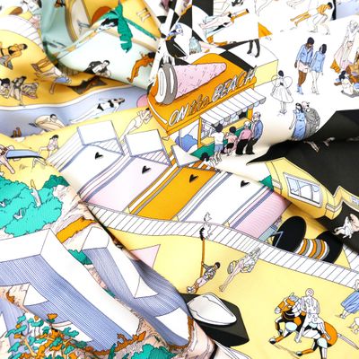 a close up of a yellow and white tie with a picture of people on it